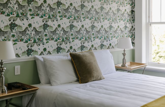 A close up of nicely made bed inside Casa Nova.