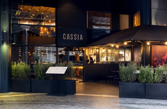 The black entrance to Cassia restaurant on a rainy day.