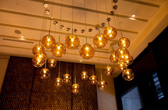 Looking up at low yellow lighting on the ceiling.