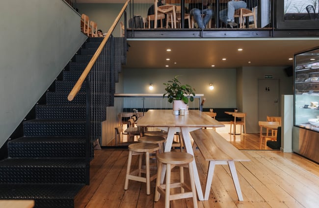 Tables and chairs inside the cafe.