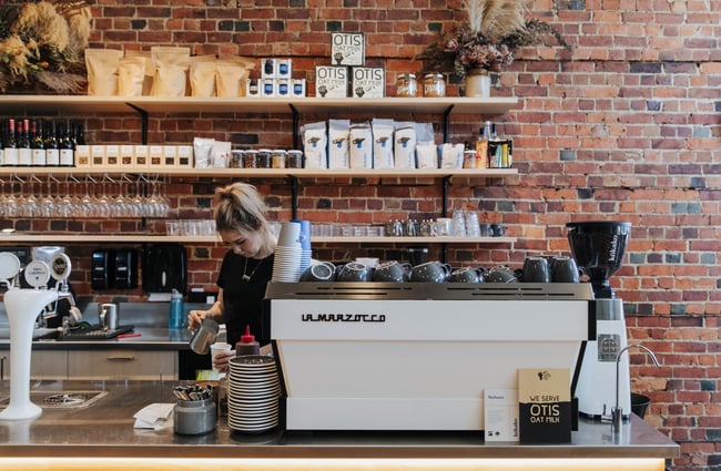 A barista making coffee.