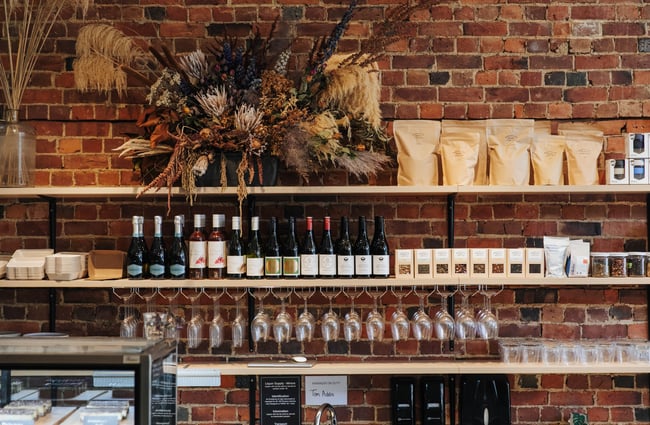 Wine bottles and glasses behind the counter.