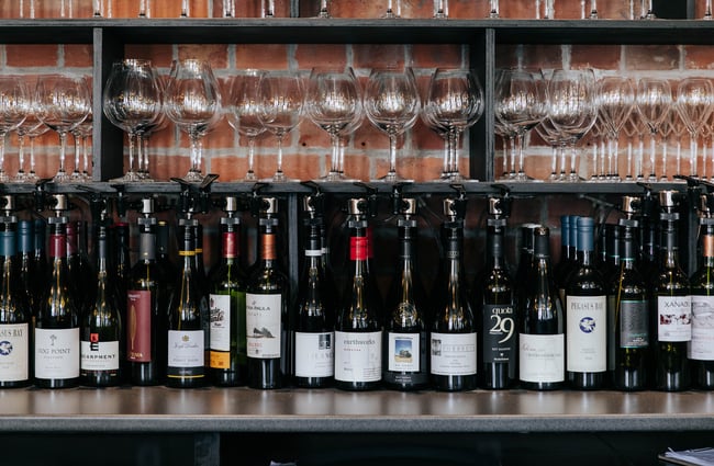 Row of wine bottles on a bar at Cellar Door in Christchurch.