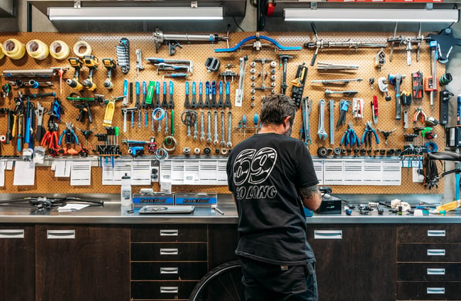 Bike mechanic working on a bike at Central Bicycle Studio.