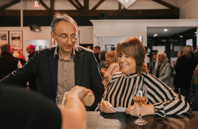 Man and a woman standing at the bar at Centrepoint Theatre.