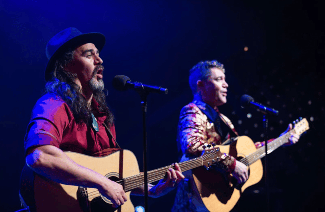 Two musicians playing guitar on stage at Centrepoint.