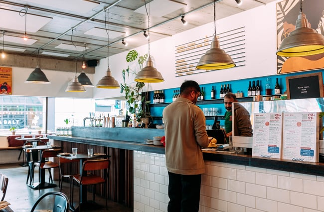 A man ordering at a counter.