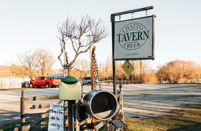 A close up of a Chatto Creek Tavern sign outside.