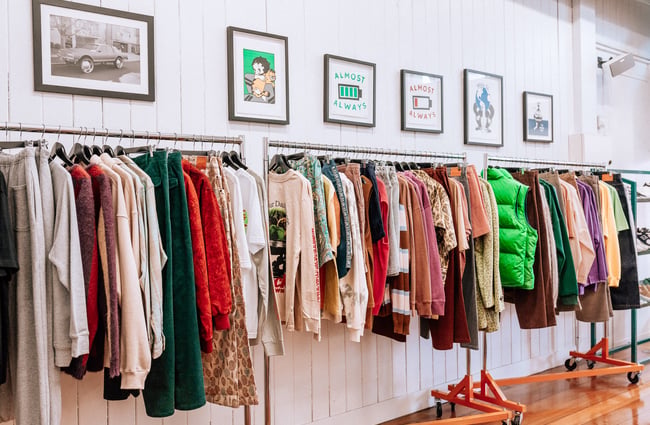 Racks of brightly coloured clothes on display.