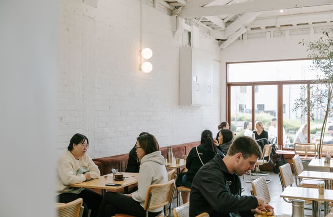 People sitting around tables at Child Sister.