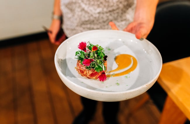 Hand holding tuna tartare at Chim Choo Ree, Hamilton.