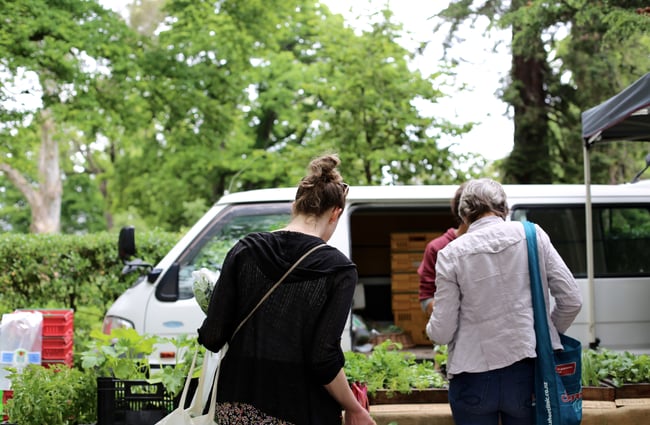 Two women shopping at Christchurch Farmers Market.