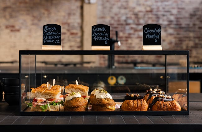 Food cabinet with sandwiches and sweet treats at Ciao within The Welder.