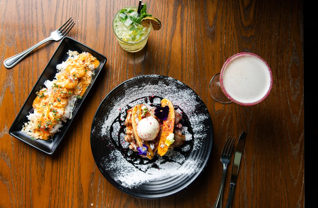 A flatlay of food and cocktails on a table.