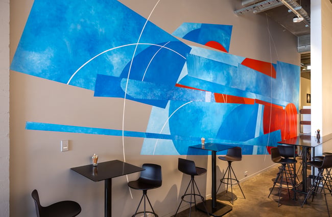 Cafe space at CoCA with bright mural