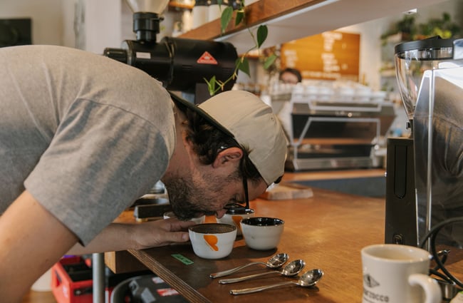 A man smelling coffee.