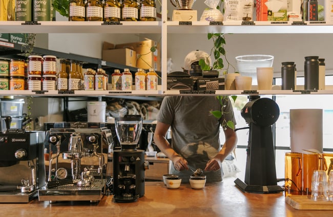 A staff member making coffee.
