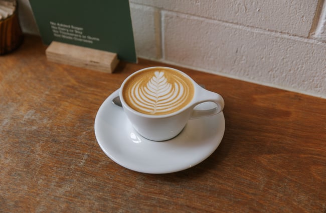 A flat white on a table.