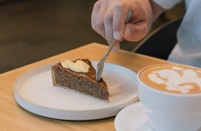 Someone spooning into cake at Coffee Embassy Cashel Street in Christchurch