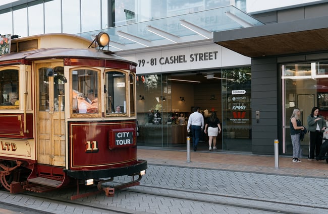 Entrance to Coffee Embassy Cashel Street in Christchurch with tram going past