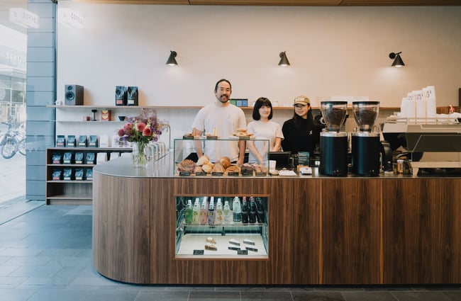 Three team members standing behind counter at Coffee Embassy Cashel Street in Christchurch