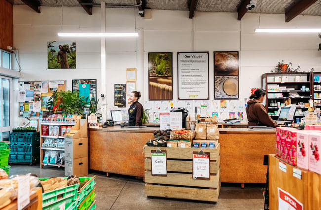 Shop assistants smiling behind front counter at Commonsense Organics in Kilbernie