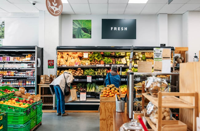 Two shoppers browsing fruit and vege fridge at Commonsense on Tory Street in Wellington
