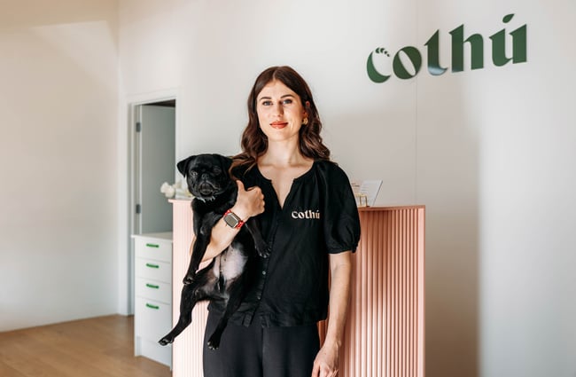 Owner holding dog in front of front counter at Cothu.