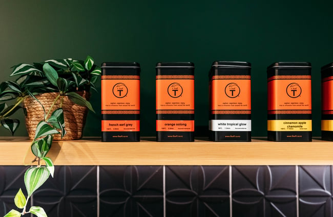 Range of teas in boxes sit along a shelf with a plant beside them at Country Road High Tea.