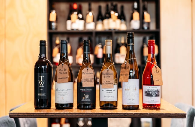 Bottles of wine lined up in a row.