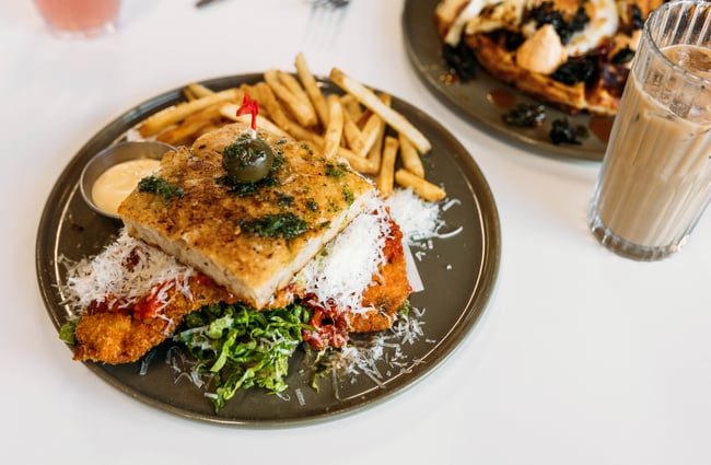 Close up of a focaccia sandwich and shoestring fries on a plate at Cream Eatery in Hamilton.
