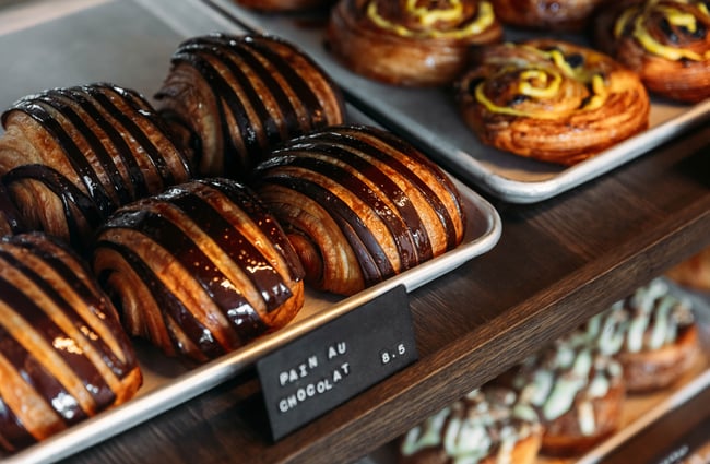 Chocolate croissants and other pastries in the cabinet at Crumb.