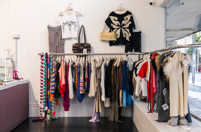 Clothes on display inside a second hand store.