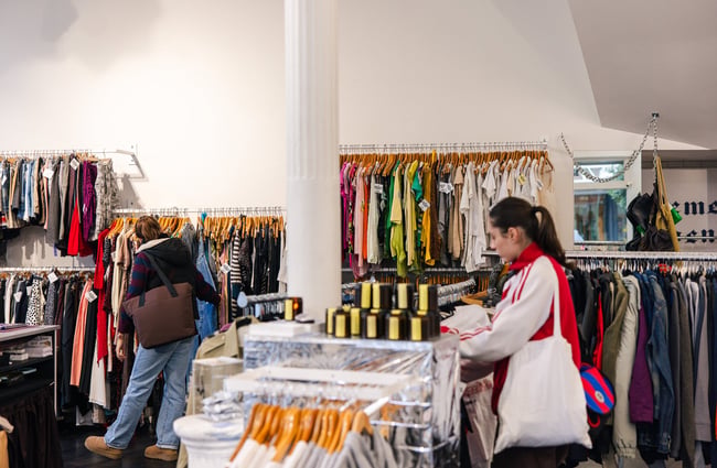 A woman browsing in a second hand store.