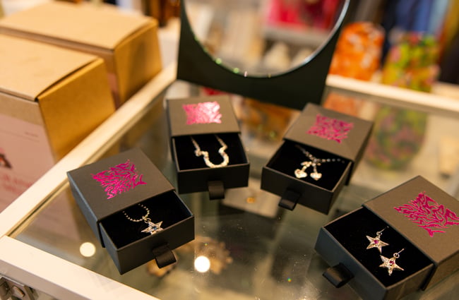 Gold jewellery in black boxes.