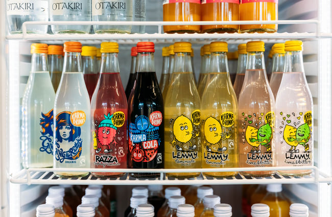 Bottles of fizzy drinks in a fridge.