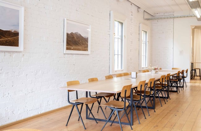 A very long table with chairs placed around every side.