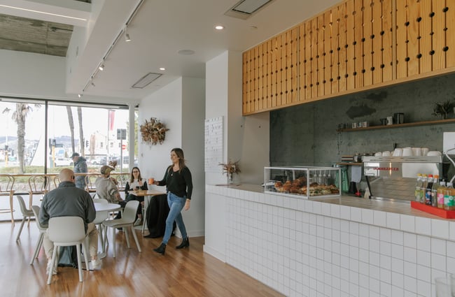 Customers sitting a table inside Dainty cafe.