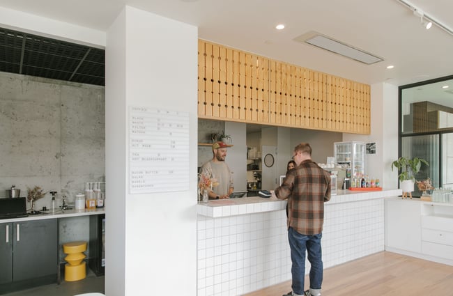 A man ordering at a cafe counter.