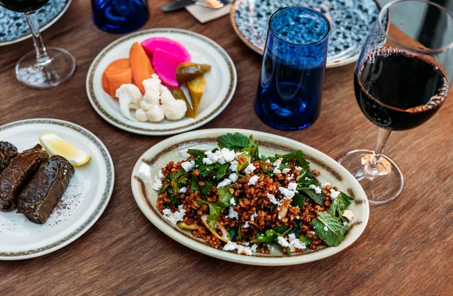 Plates of food and wine on the table at Damascus.