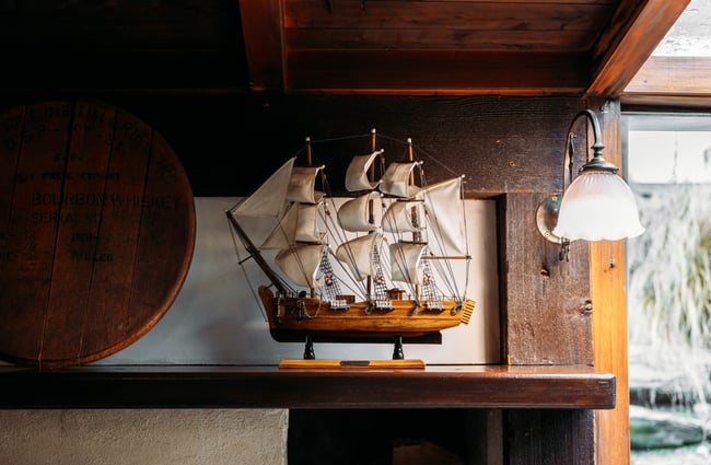 A sail boat on a shelf.