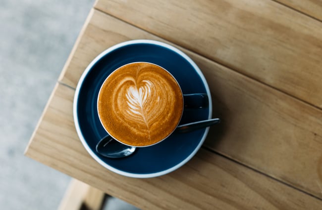 A birdseye view of a flat white on a table.