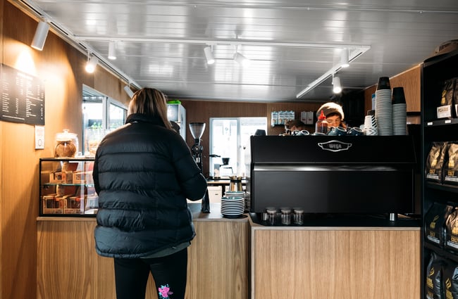 A customer ordering inside the tiny cafe space.