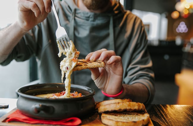 Man eating fondue dish at Dark Sky Diner, Tekapo.