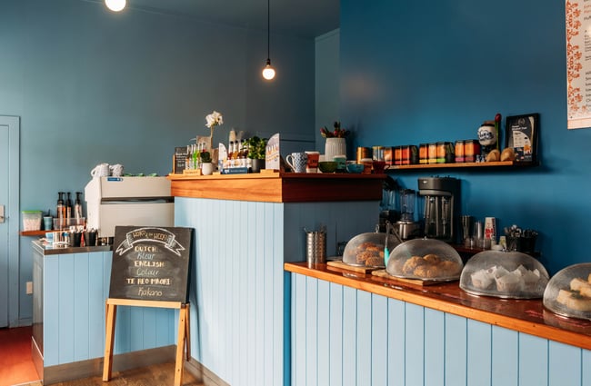 The cafe front counter with food displayed and the coffee machine at De Molen.