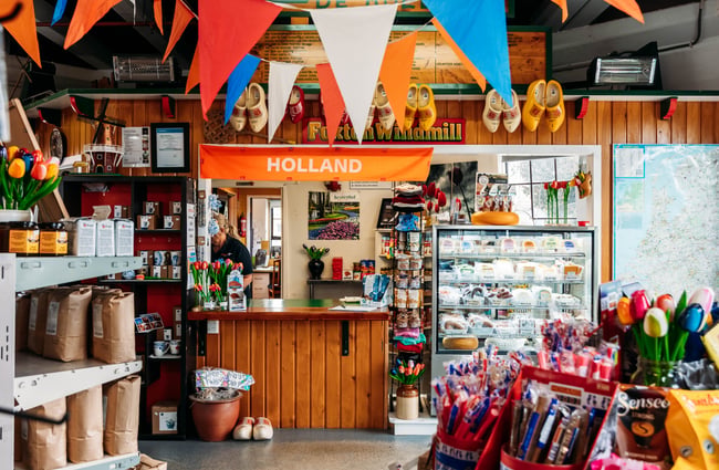 Front counter at the market shop complete with Holland signage and orange, white and blue bunting at De Molen.