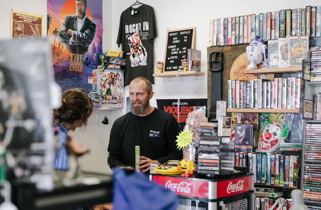 Evan chatting to a customer at Dead Video in Lyttelton.