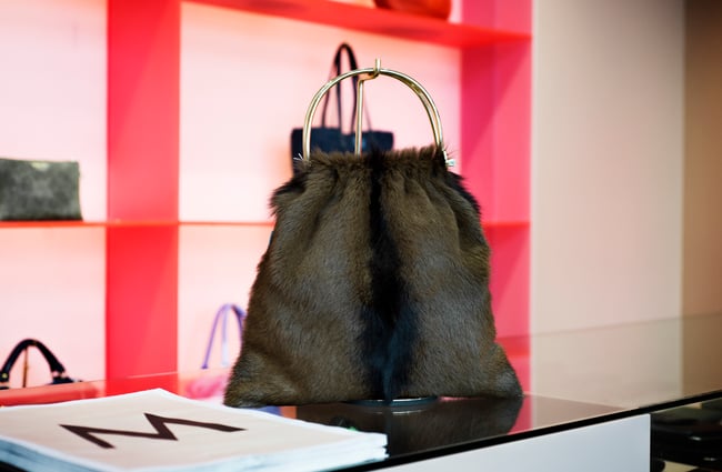 Black bag by red wall.