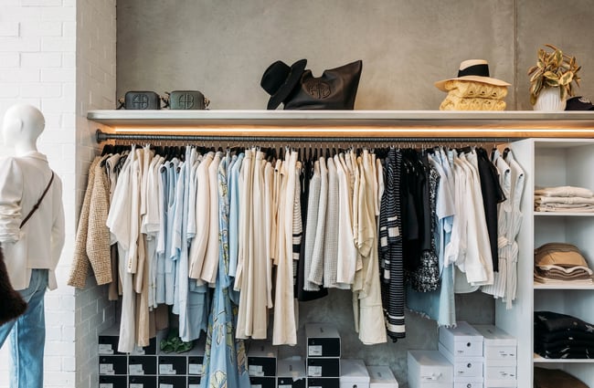 Rack of blue, cream, white and black women's clothing at DEVàl Boutique, Wānaka.