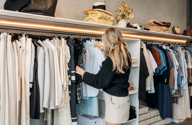 A woman looks through a rack of clothing in DEVàl Boutique, Wānaka.
